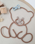 Knitted bear/teddy, with flower or bow accessory